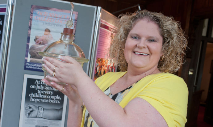 Louise Brown holding the desiccator in which she was created