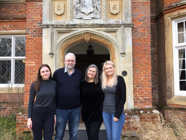 Nina and family in front of Bourn Hall